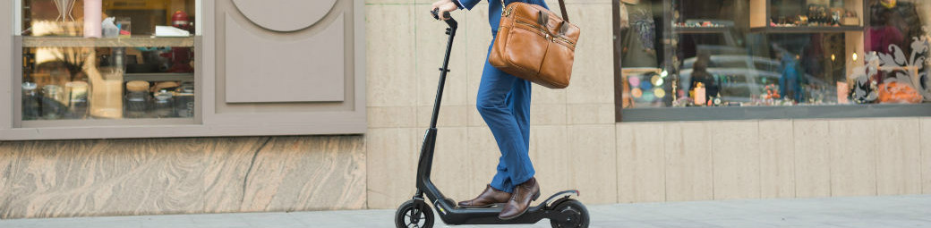header – guy on scooter on sidewalk